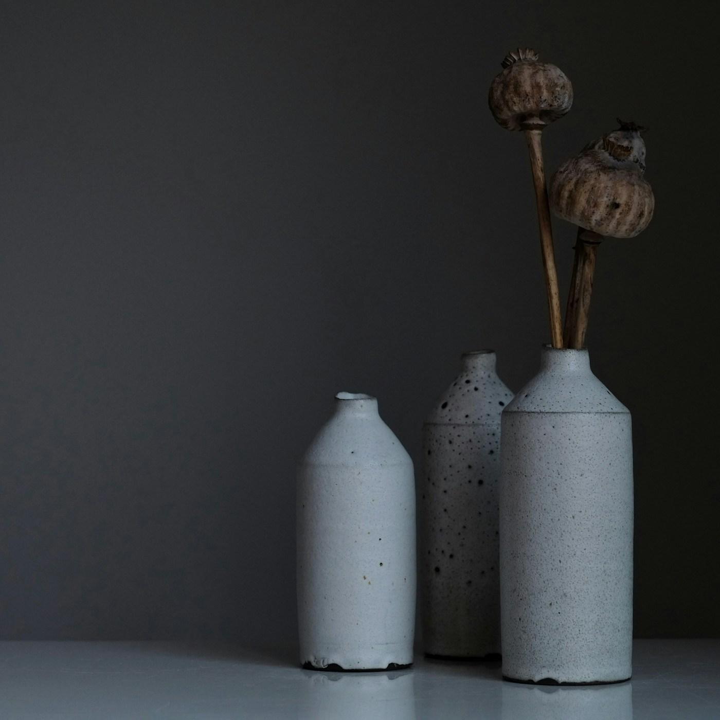 Close-up of weathered hands holding a ceramic bowl